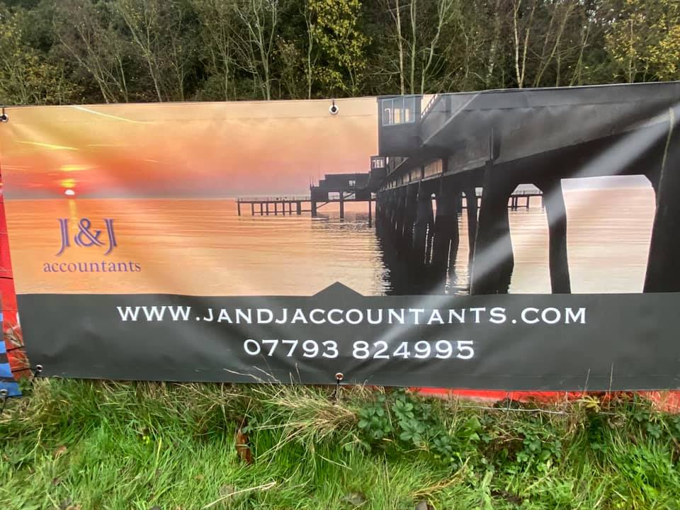 J&J Accountants sponsorship banner at a cycling event